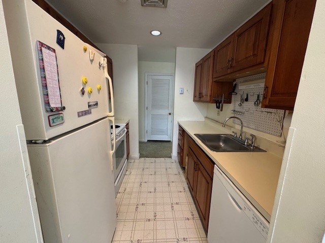 140 High St Unit 108, Westerly, RI 02891 - kitchen with recessed lighting, light floors, white appliances, light countertops, and a sink