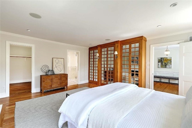 750 Elmgrove Ave, Providence, RI 02906 - bedroom featuring baseboards, ornamental molding, wood finished floors, and a spacious closet