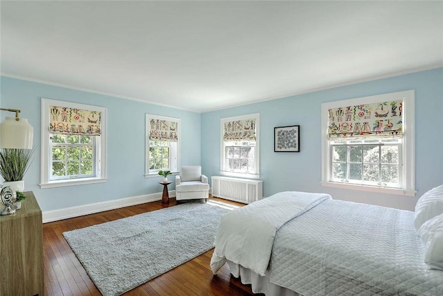 750 Elmgrove Ave, Providence, RI 02906 - bedroom featuring dark wood-style flooring, baseboards, ornamental molding, and radiator heating unit
