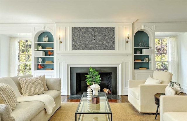 750 Elmgrove Ave, Providence, RI 02906 - living area featuring a fireplace with flush hearth, built in features, dark wood-style floors, and a wealth of natural light