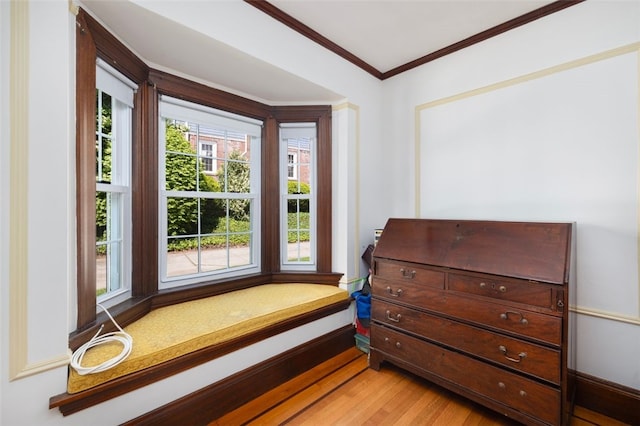 entryway featuring crown molding and light wood-style floors