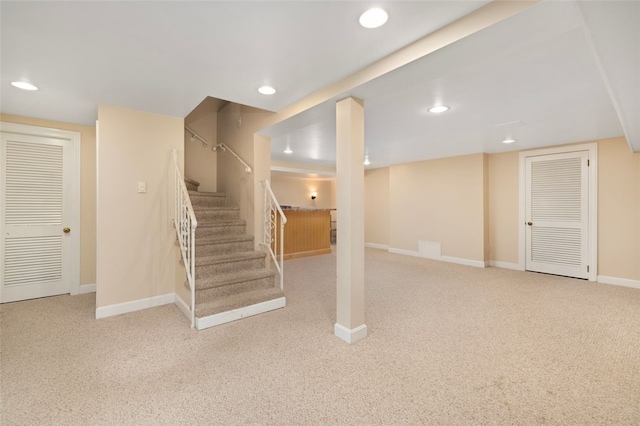 finished below grade area with carpet, recessed lighting, stairs, and baseboards