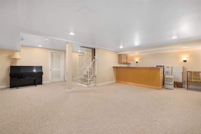 finished basement with light carpet, recessed lighting, stairs, a bar, and baseboards