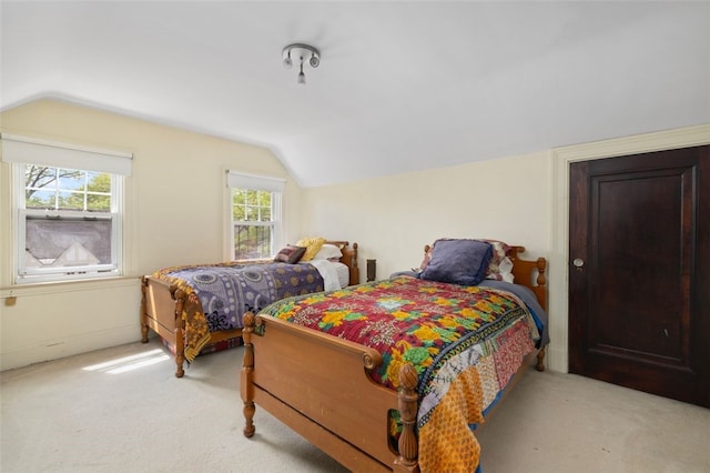 carpeted bedroom with vaulted ceiling