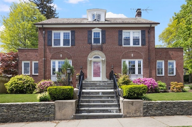 colonial home with brick siding