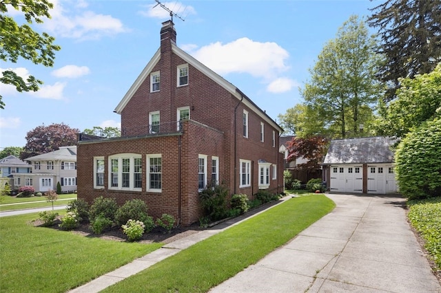 view of side of property with brick siding, an outdoor structure, a chimney, and a yard
