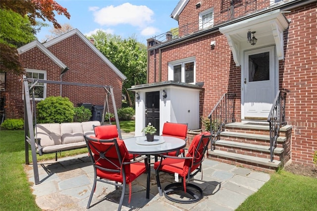 view of patio / terrace featuring outdoor dining space and entry steps