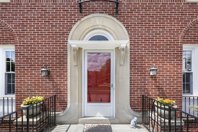 doorway to property with brick siding
