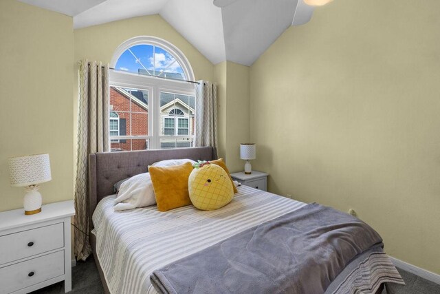 bedroom with baseboards, vaulted ceiling, and carpet floors