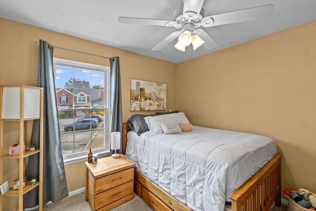 carpeted bedroom with a ceiling fan and baseboards