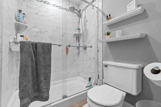 bathroom with a stall shower and toilet