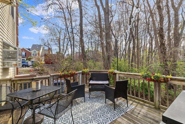 wooden terrace featuring outdoor dining area