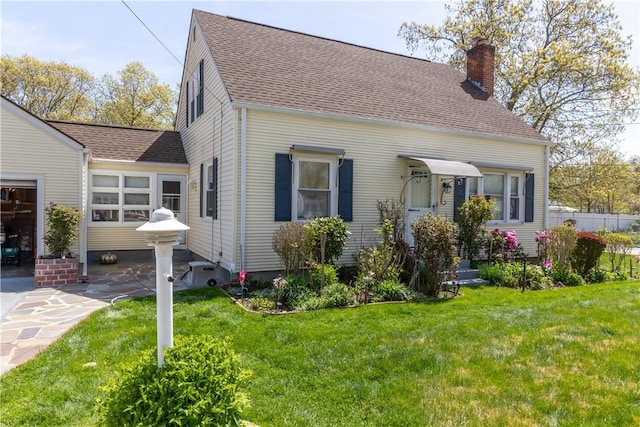 132 Bakers Creek Rd, Warwick, RI 02886 - back of house with roof with shingles, a chimney, and a yard