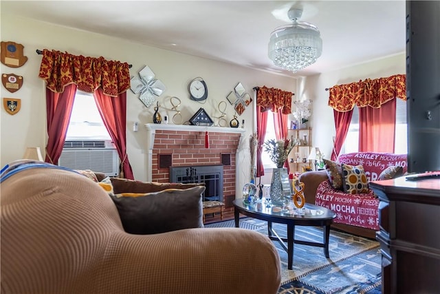 132 Bakers Creek Rd, Warwick, RI 02886 - living area featuring a brick fireplace, a chandelier, and cooling unit