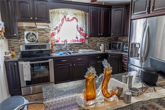 132 Bakers Creek Rd, Warwick, RI 02886 - kitchen with a sink, dark stone countertops, appliances with stainless steel finishes, and backsplash