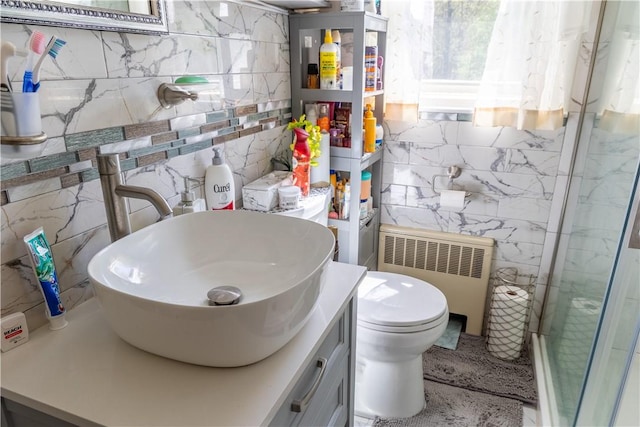 132 Bakers Creek Rd, Warwick, RI 02886 - full bathroom with vanity, toilet, radiator heating unit, tile walls, and an enclosed shower