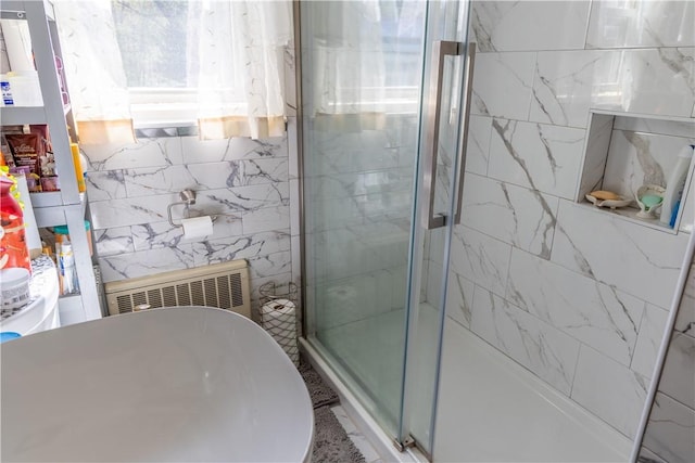 132 Bakers Creek Rd, Warwick, RI 02886 - bathroom featuring radiator heating unit, tile walls, and a shower stall