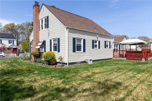 132 Bakers Creek Rd, Warwick, RI 02886 - rear view of property featuring a chimney, a deck, a gazebo, a yard, and a shingled roof