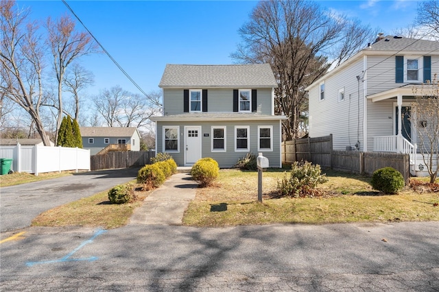 view of front of home featuring driveway and fence
