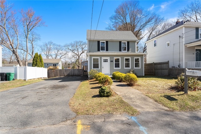 view of front of house featuring driveway and fence