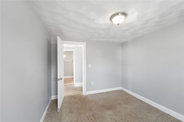 unfurnished bedroom with carpet and baseboards