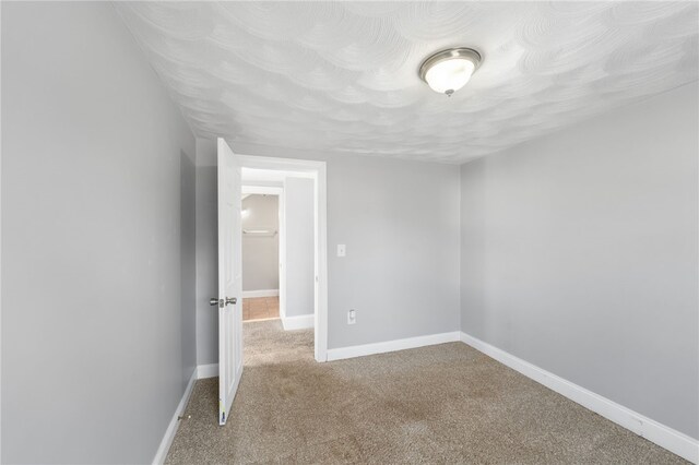 unfurnished bedroom with carpet and baseboards