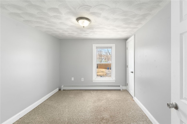 unfurnished room featuring a baseboard heating unit, a textured ceiling, light colored carpet, and baseboards