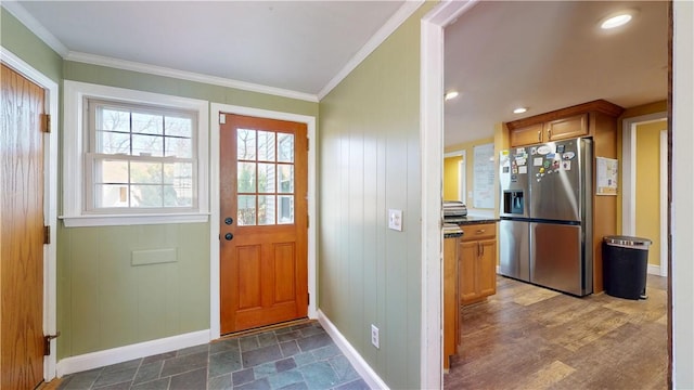 entryway with baseboards and ornamental molding