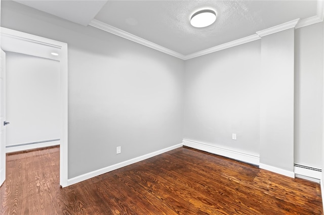 empty room with wood finished floors, ornamental molding, and a baseboard radiator