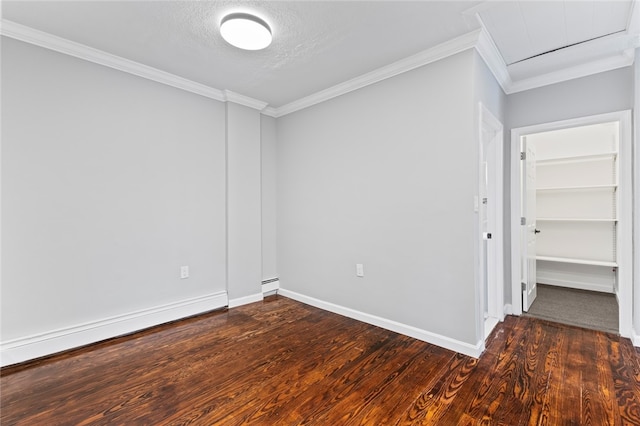 empty room with ornamental molding, a baseboard radiator, wood finished floors, and baseboards