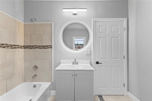 bathroom featuring tile patterned flooring, bathing tub / shower combination, vanity, and baseboards