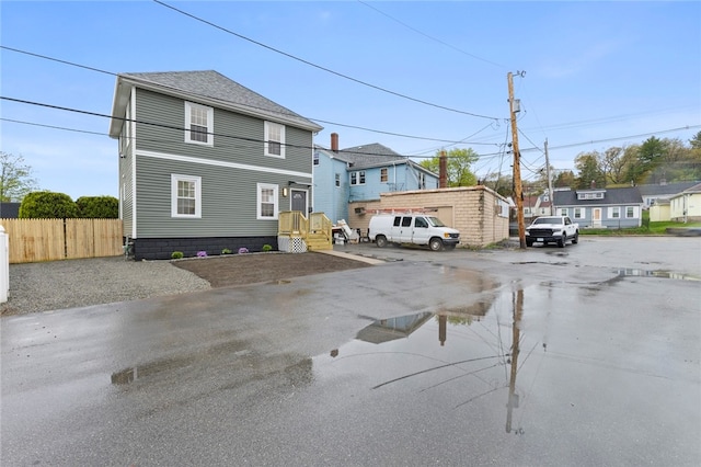 exterior space with fence and uncovered parking