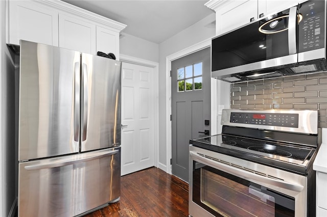 kitchen featuring dark wood finished floors, white cabinets, stainless steel appliances, and tasteful backsplash