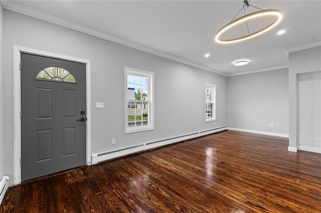 foyer entrance with a baseboard heating unit, baseboard heating, ornamental molding, and wood finished floors