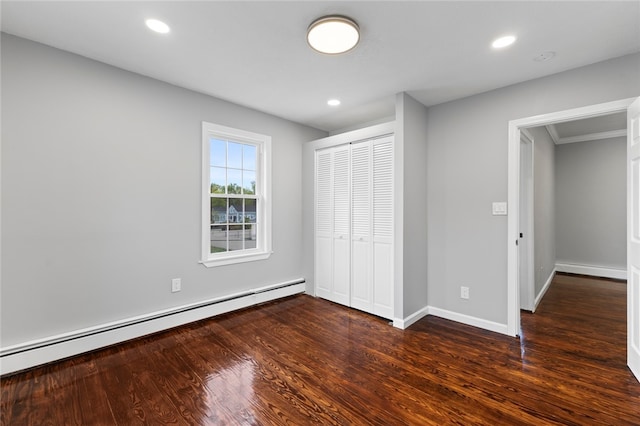 unfurnished bedroom featuring dark wood-type flooring, recessed lighting, a closet, and a baseboard radiator