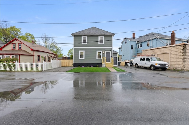 american foursquare style home featuring fence