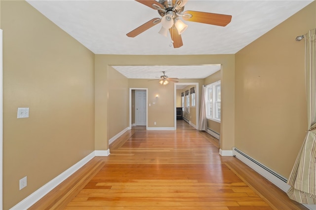 hall with light wood finished floors, baseboards, and a baseboard radiator