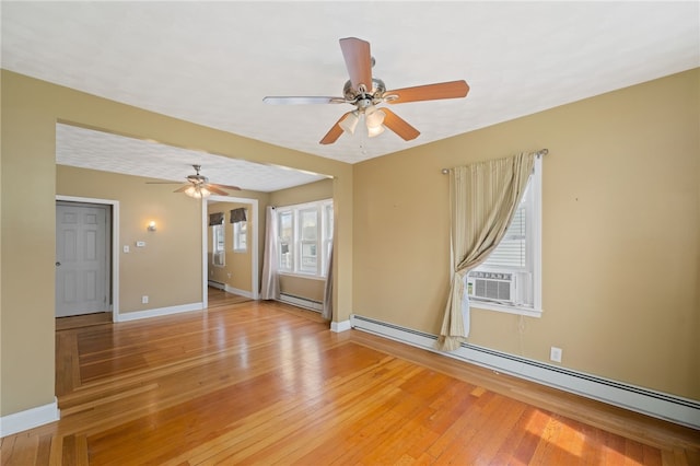 empty room with baseboard heating, a ceiling fan, light wood-style floors, and a baseboard radiator