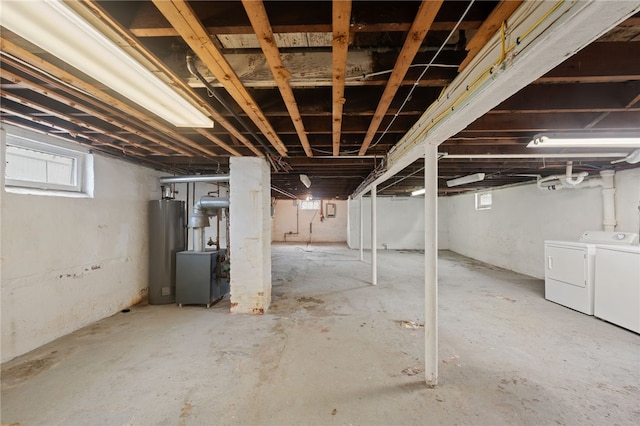 basement featuring water heater and washing machine and dryer