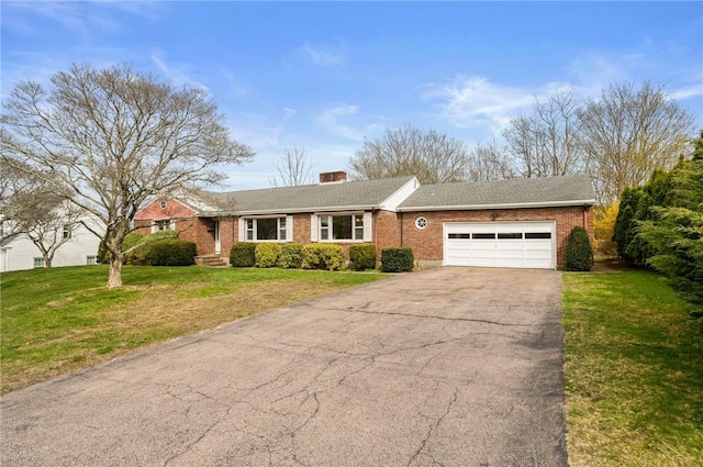 21 Top St, Westerly, RI 02891 - ranch-style house featuring brick siding, driveway, a front yard, and a garage