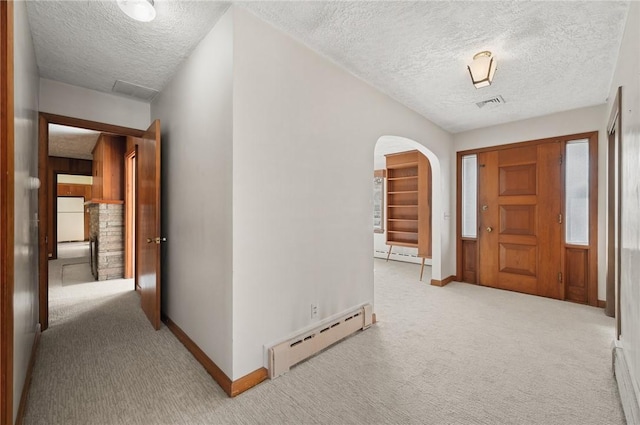 21 Top St, Westerly, RI 02891 - hall with carpet flooring, arched walkways, a textured ceiling, baseboards, and a baseboard heating unit