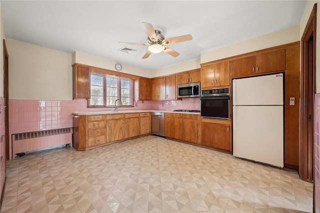21 Top St, Westerly, RI 02891 - kitchen with a ceiling fan, brown cabinets, light countertops, radiator, and stainless steel appliances