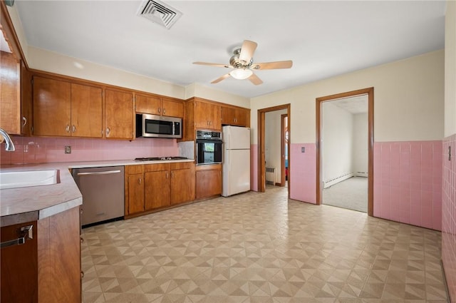 21 Top St, Westerly, RI 02891 - kitchen with visible vents, appliances with stainless steel finishes, brown cabinets, a sink, and a baseboard radiator
