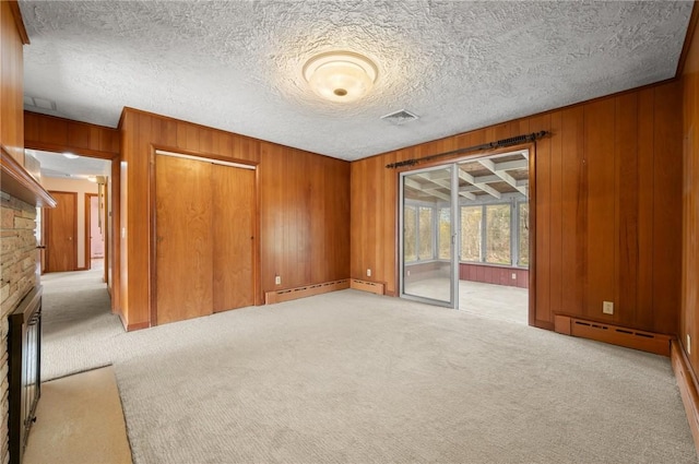 21 Top St, Westerly, RI 02891 - spare room with wooden walls, visible vents, light carpet, and a baseboard radiator