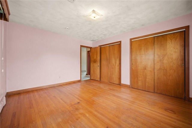 21 Top St, Westerly, RI 02891 - unfurnished bedroom featuring baseboards, multiple closets, and light wood-type flooring