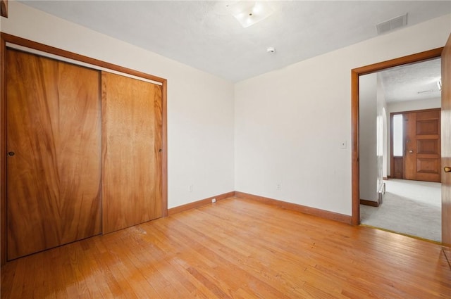 21 Top St, Westerly, RI 02891 - unfurnished bedroom with light wood-type flooring, baseboards, visible vents, and a closet
