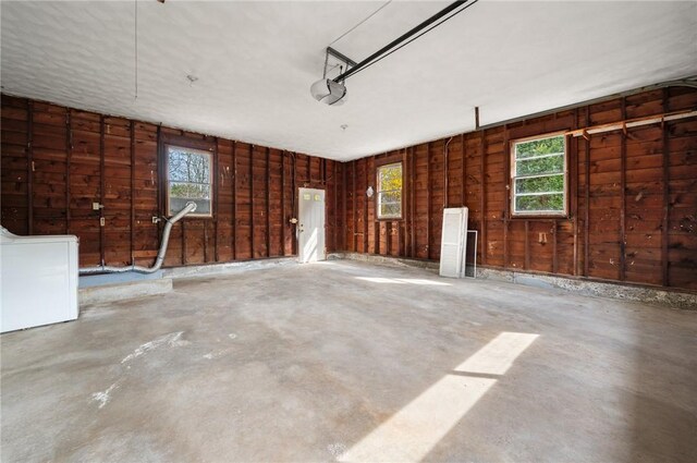 21 Top St, Westerly, RI 02891 - garage featuring a garage door opener, wood walls, and washer / clothes dryer