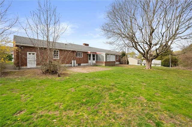21 Top St, Westerly, RI 02891 - back of property with brick siding, a lawn, a patio area, and a chimney