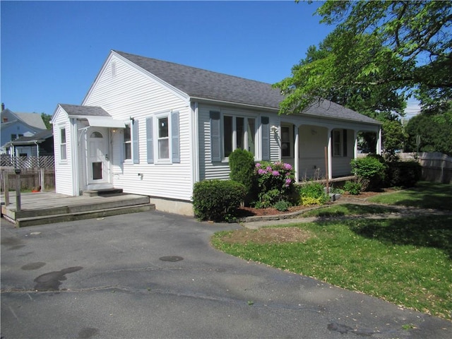 23 Pengrove St, Cranston, RI 02920 - view of front of house featuring a shingled roof, covered porch, and a front lawn
