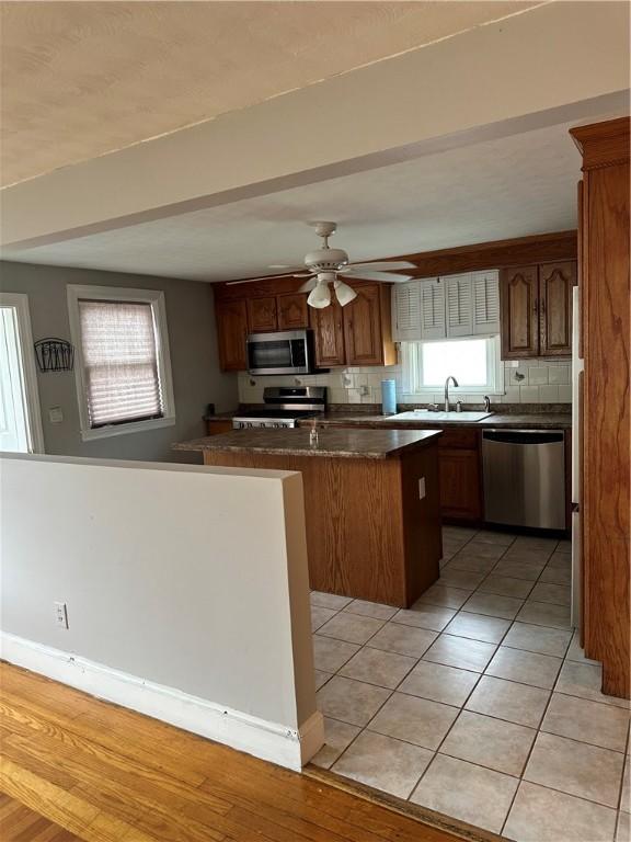 23 Pengrove St, Cranston, RI 02920 - kitchen with appliances with stainless steel finishes, a sink, plenty of natural light, and dark countertops